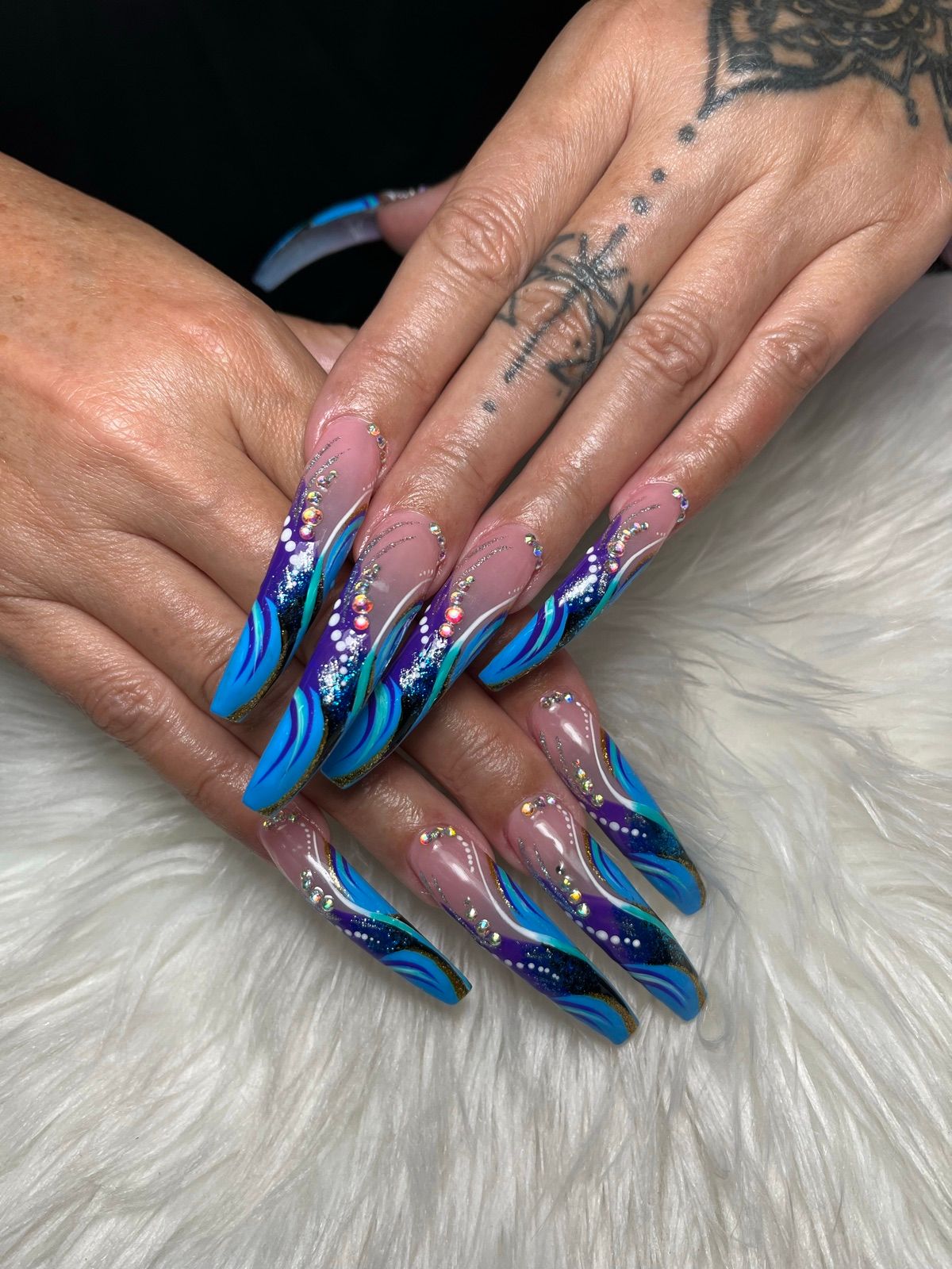 Extra-long blue and purple swirl coffin nails with rhinestones