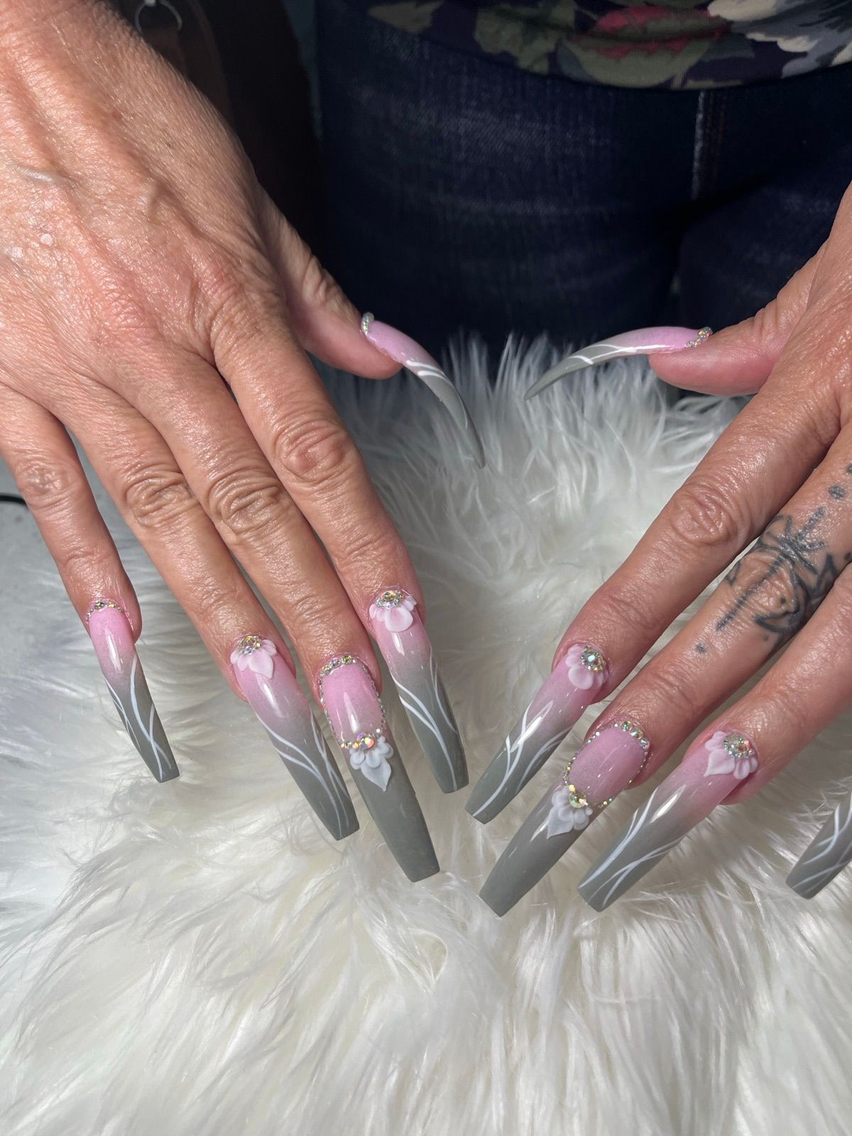 Extra-long pink and grey ombre coffin nails with white swirls and rhinestones