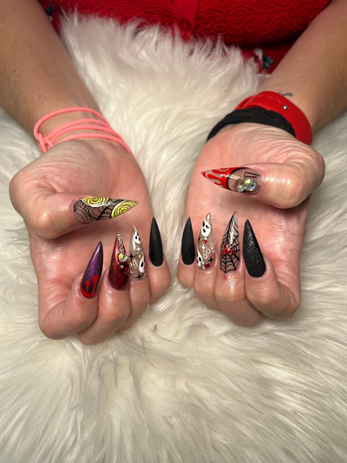 Halloween stiletto nails with spider webs, ghosts and black and red accents