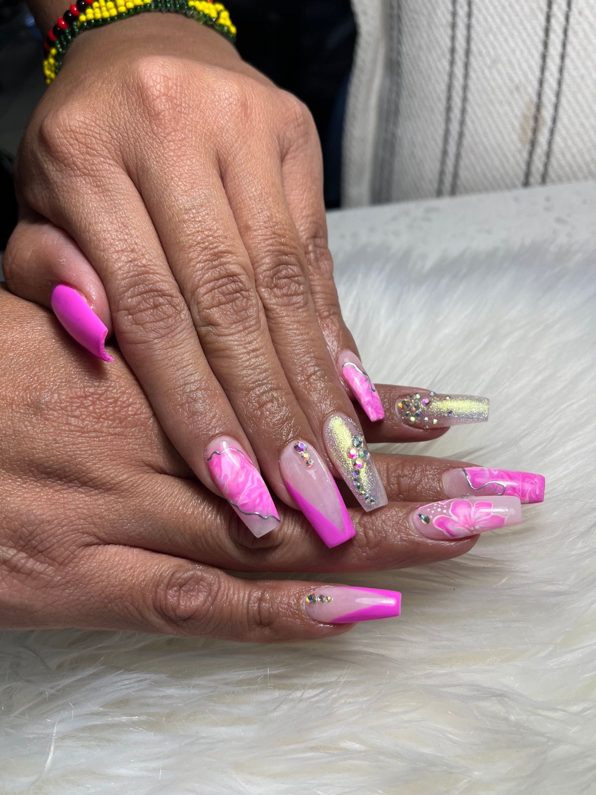 Long hot pink coffin nails with pink marble, gold glitter and rhinestones