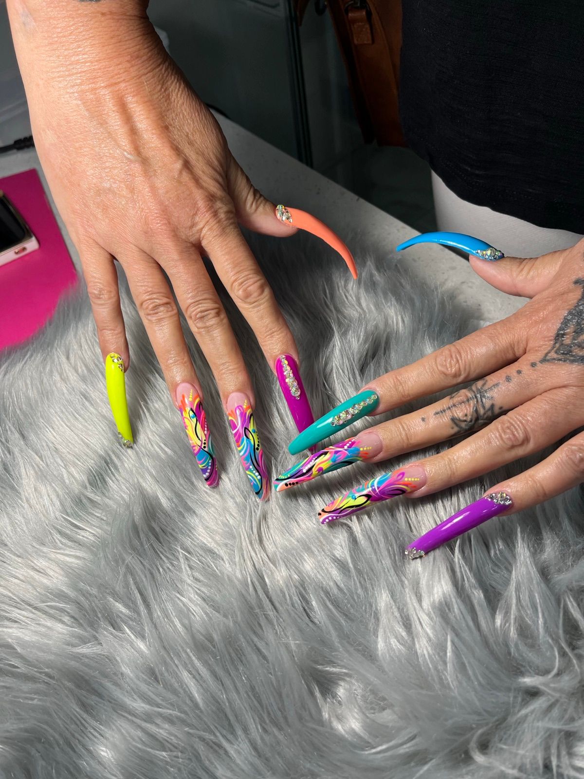 Extra-long neon coffin nails with abstract swirl art and rhinestones