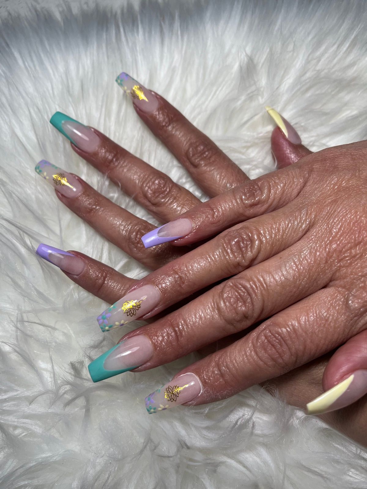 Long coffin nails with pastel teal, lilac and yellow French tips and gold foil