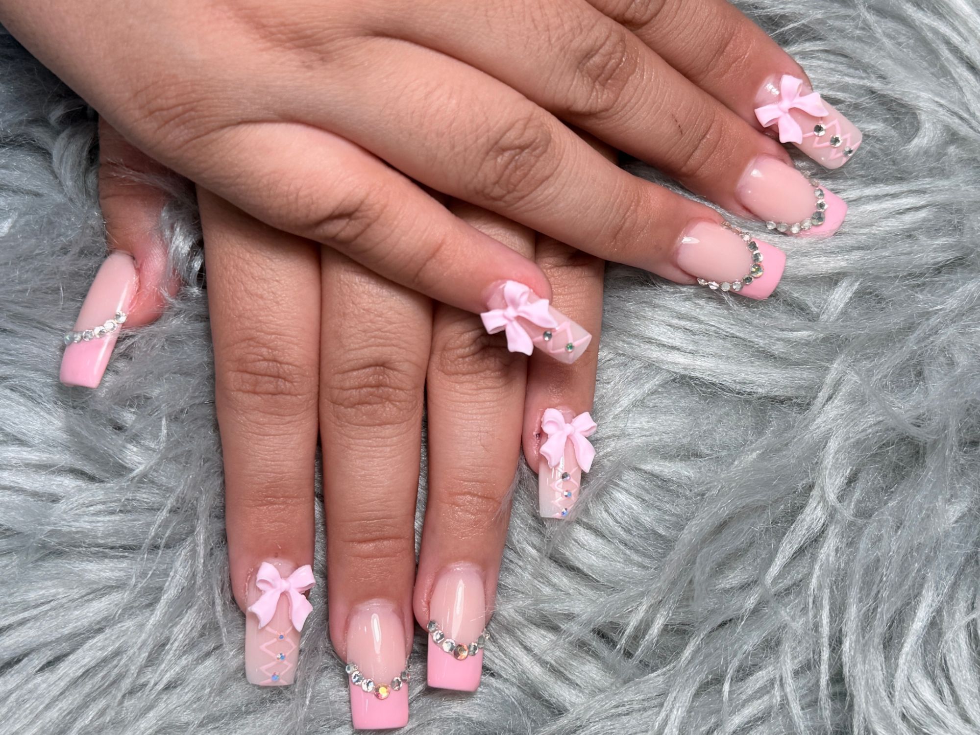 Pink French tip square nails with 3D bows and rhinestones
