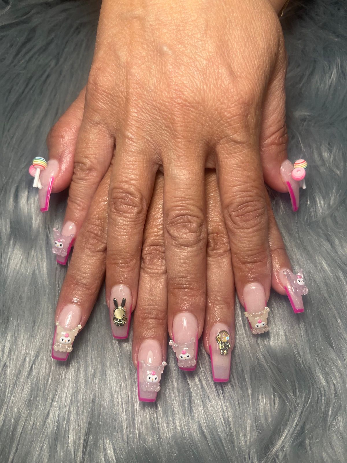 Long square nails with hot pink French tips and 3D cartoon charms