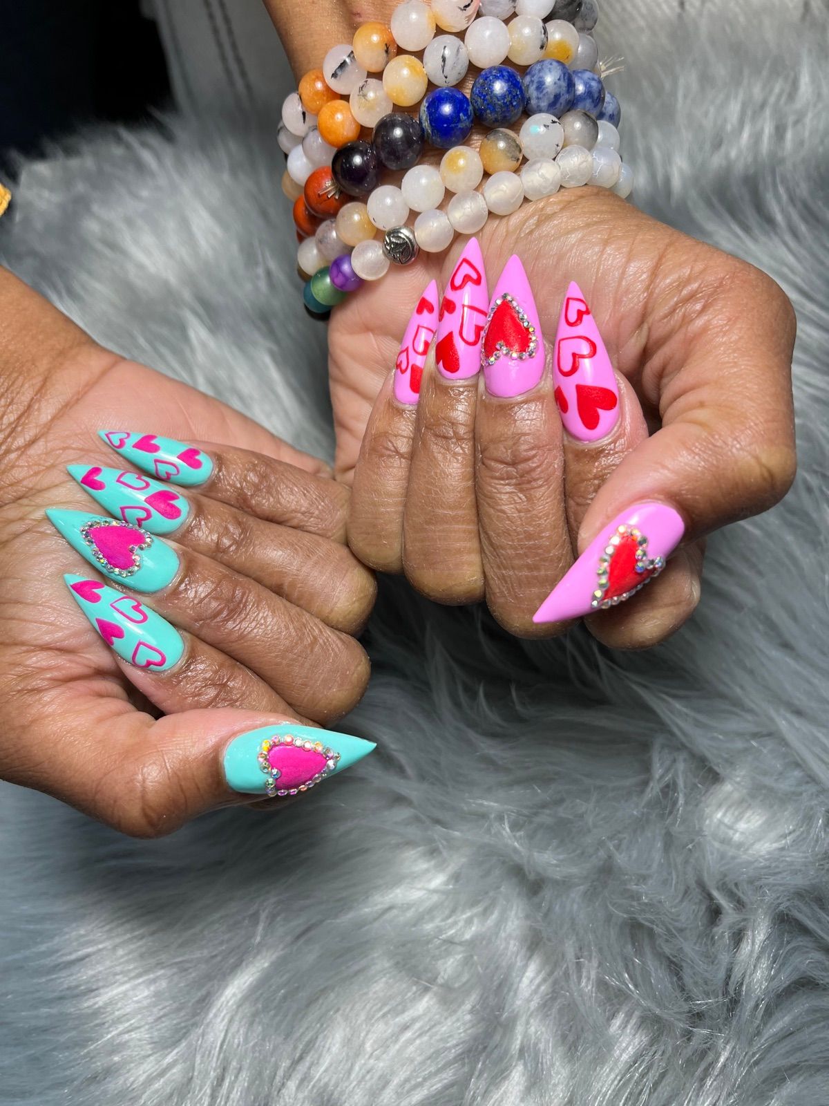 Pink and mint stiletto nails with red rhinestone hearts