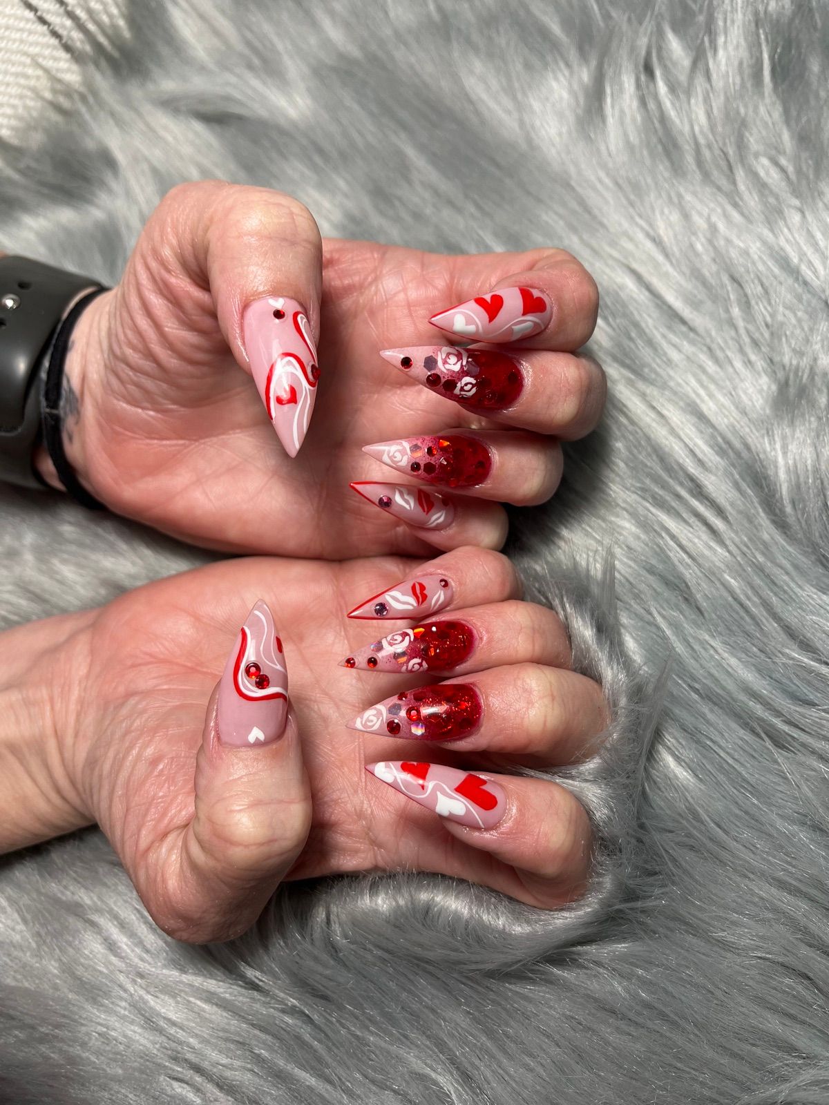 Pink and red Valentine's stiletto nails with hearts and red glitter