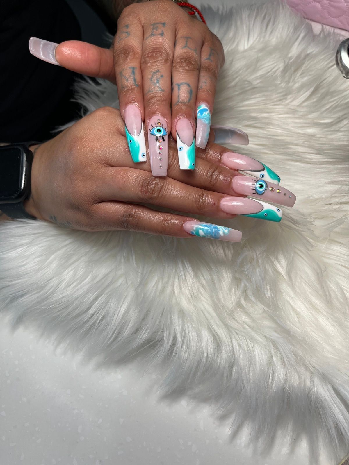 Long coffin nails with turquoise French tips and evil eye charms